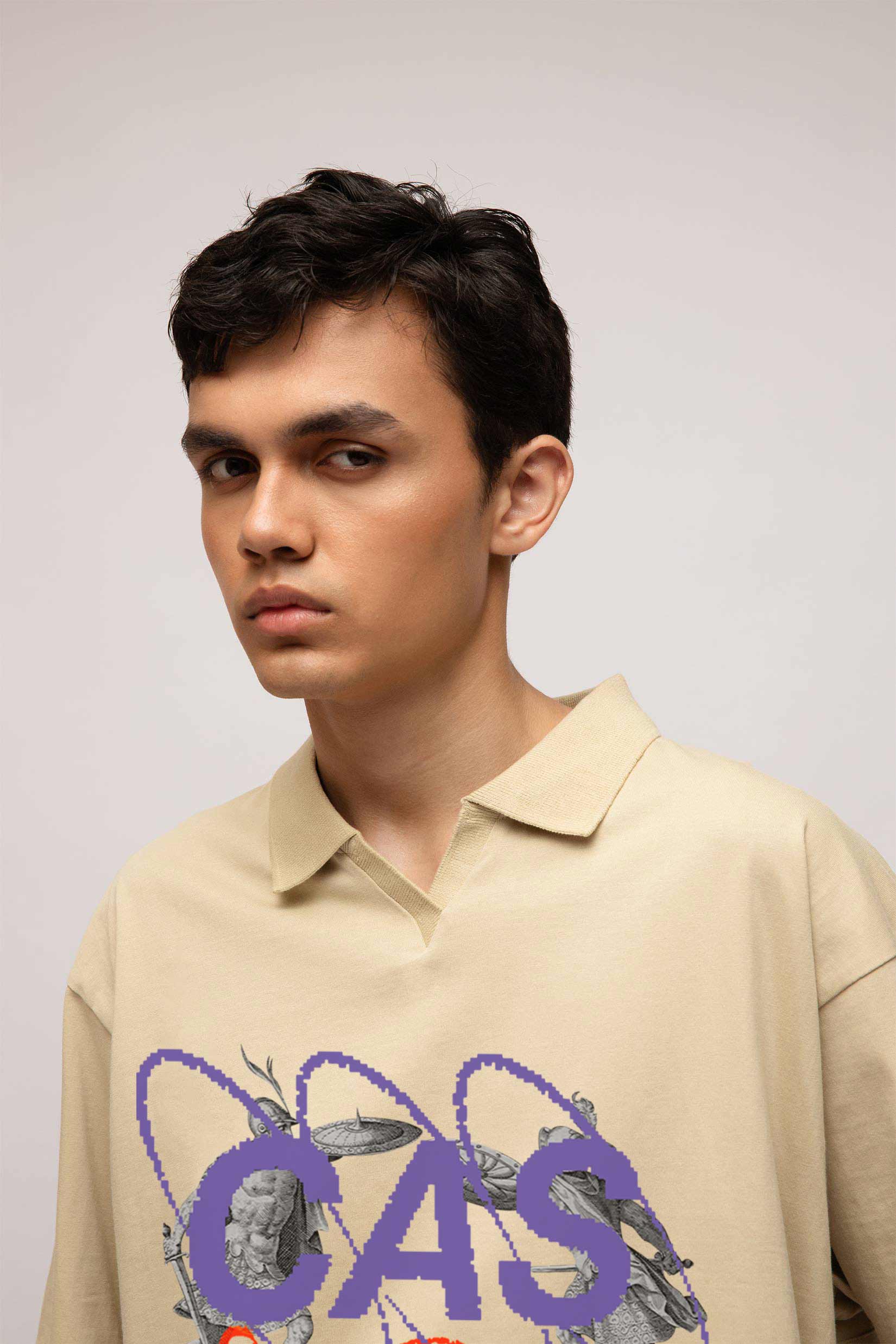 Stylera beige graphic polo shirt for men on model with purple CAS insect print and relaxed oversized fit