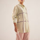 Stylera green embroidered oversized shirt worn by model with pink pants and pearl handbag