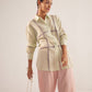Stylera green embroidered oversized shirt worn by model with pink wide-leg pants and accessories