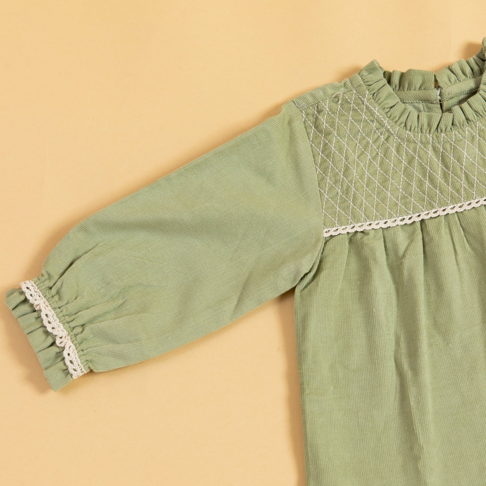 Stylera green girls dress with puffy sleeves and beautiful smocked detailing