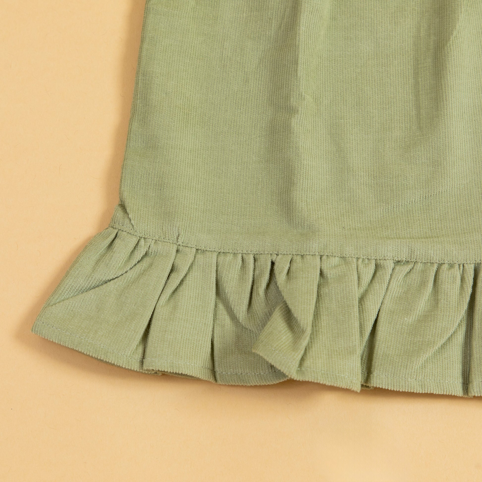 Stylera Green Girls Dress featuring a ruffled hem for a playful look