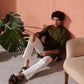 Stylish green Jodhpuri kurta paired with white trousers, set in a modern indoor space