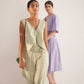 Stylera green lace straight fit trousers worn by model with sleeveless top in soft lighting