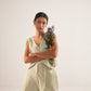 Stylera green lace straight fit trousers worn by woman holding a bouquet of flowers
