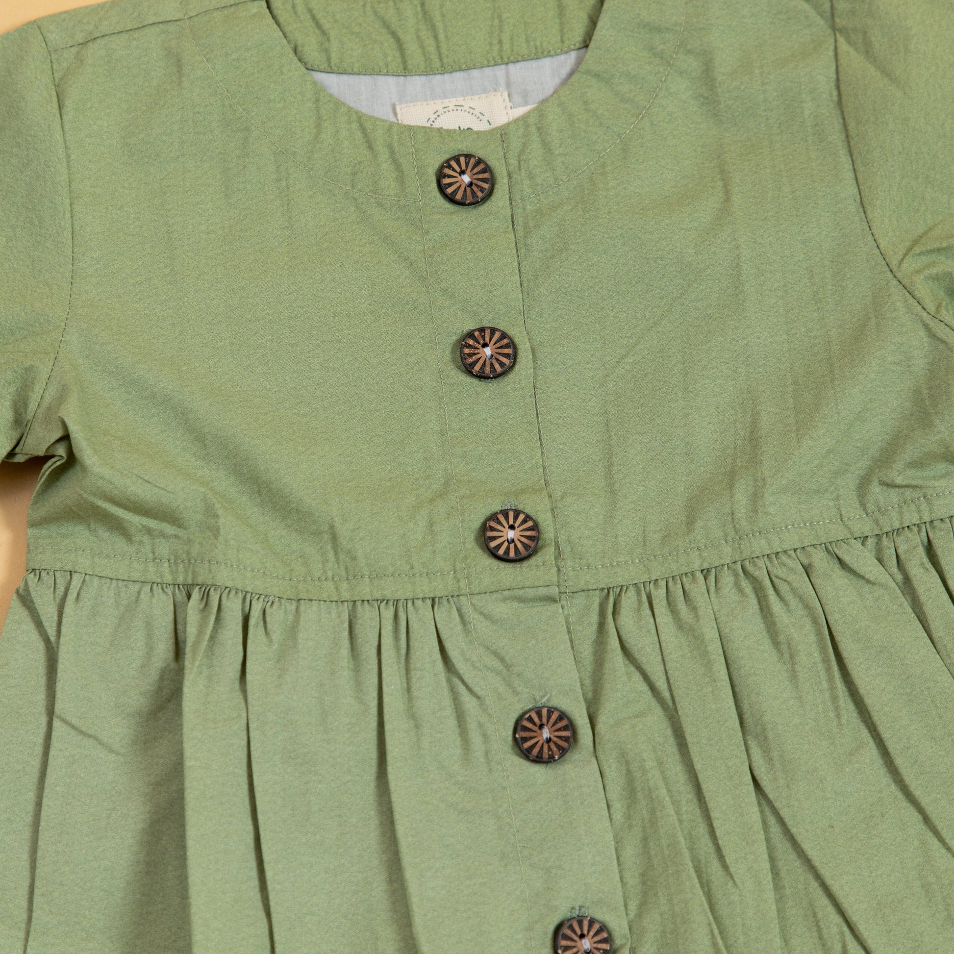 Green peplum outfit for women featuring stylish buttons and a comfortable fit