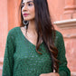 Woman wearing a green three piece suit for women with intricate embroidery by Stylera