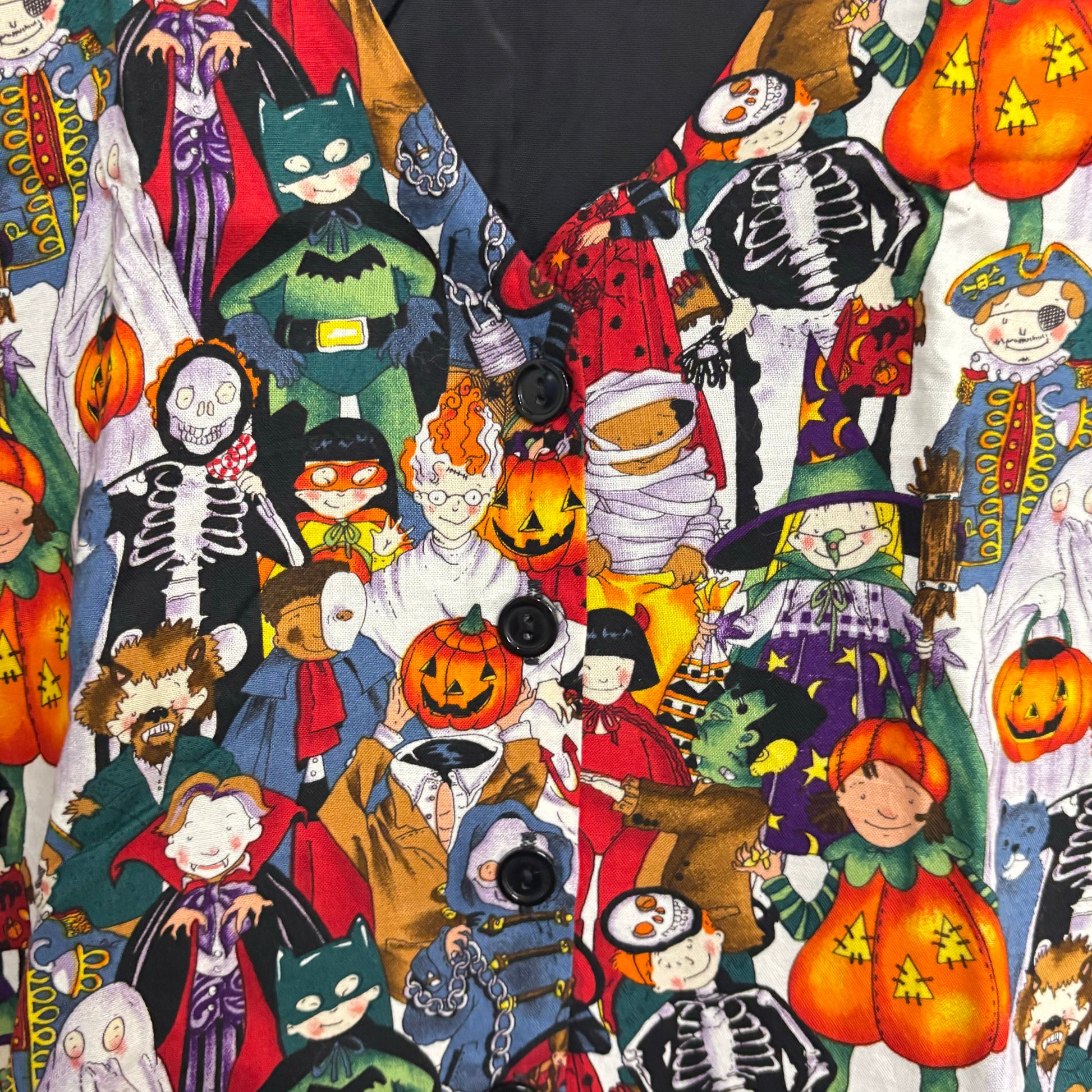 Halloween costume vest for adults featuring colorful cartoon Halloween characters pumpkins skeletons and black buttons