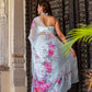 Elegant woman in a handcrafted saree with floral print, showcasing vibrant colors and delicate design.