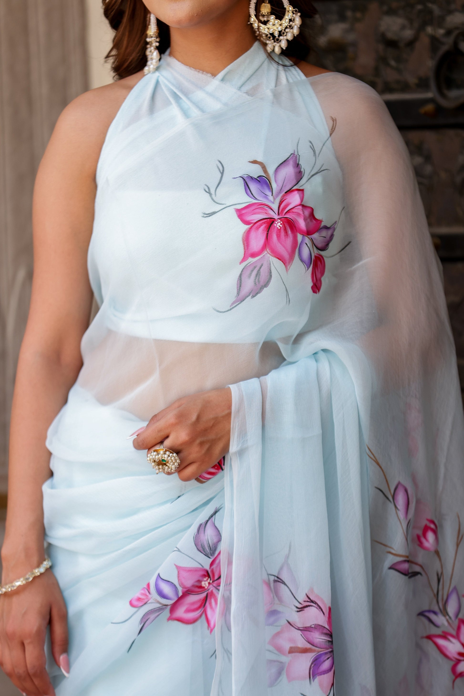 Elegant handcrafted saree with floral print in light blue, perfect for formal occasions or festive wear.