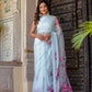 Stylish model wearing a handcrafted saree with floral print, showcasing vibrant colors and elegant design
