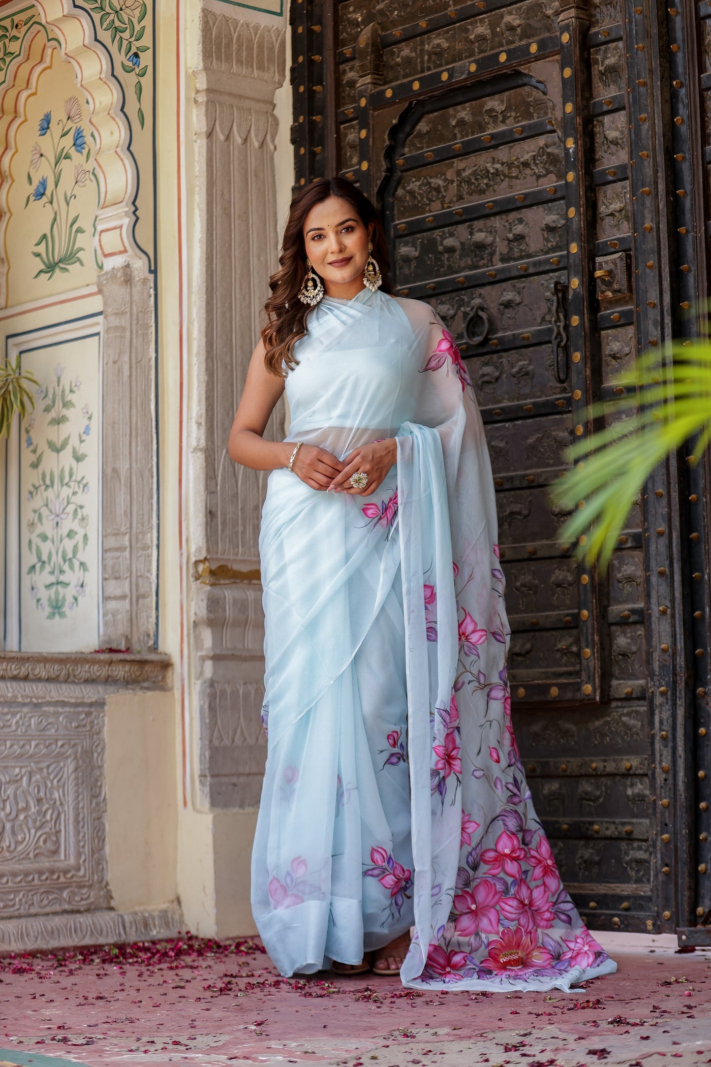 Stylish model wearing a handcrafted saree with floral print, showcasing vibrant colors and elegant design