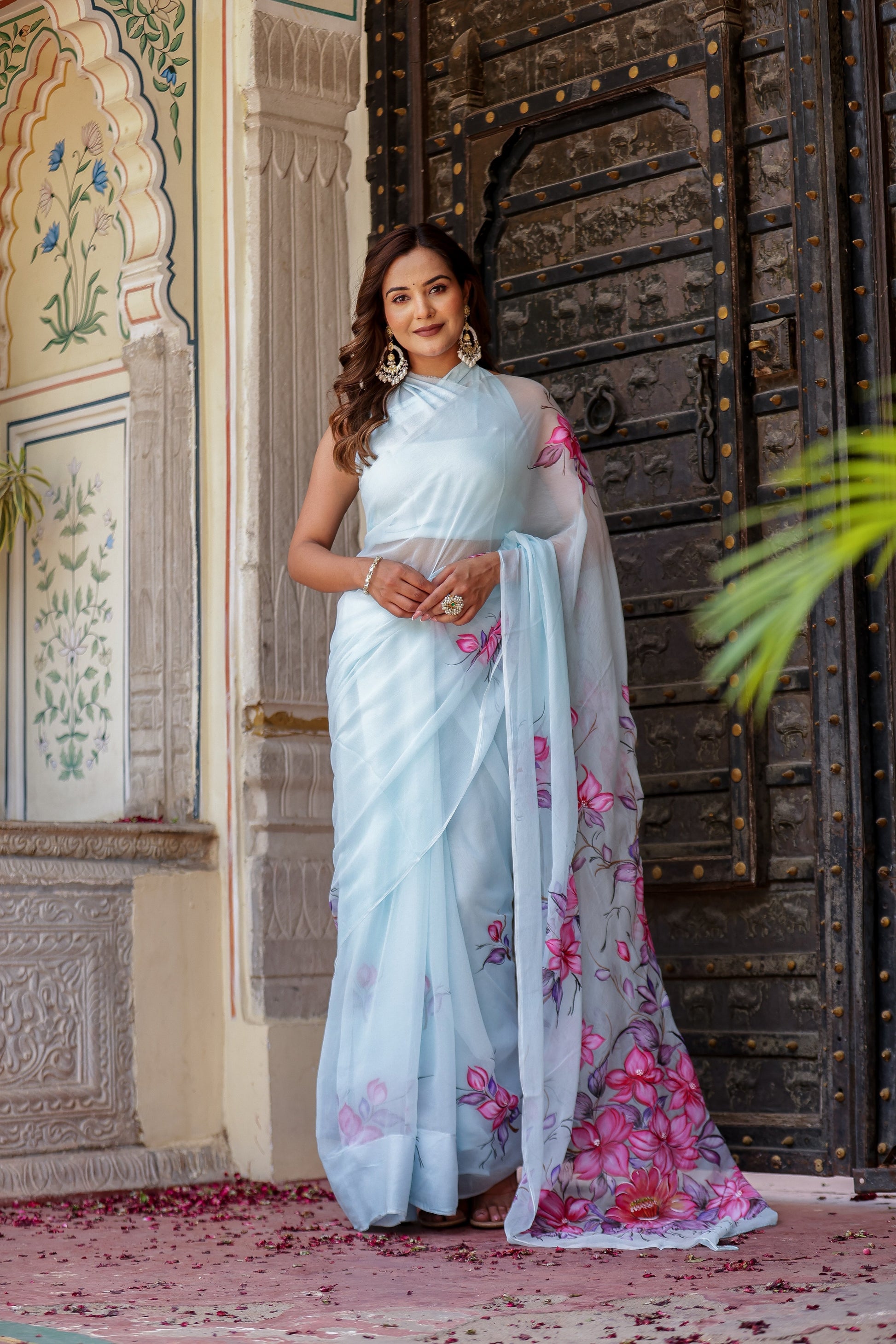 Stylish model wearing a handcrafted saree with floral print, showcasing vibrant colors and elegant design