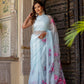 Elegant Stylera handcrafted saree with floral print, featuring a light blue fabric and delicate floral designs