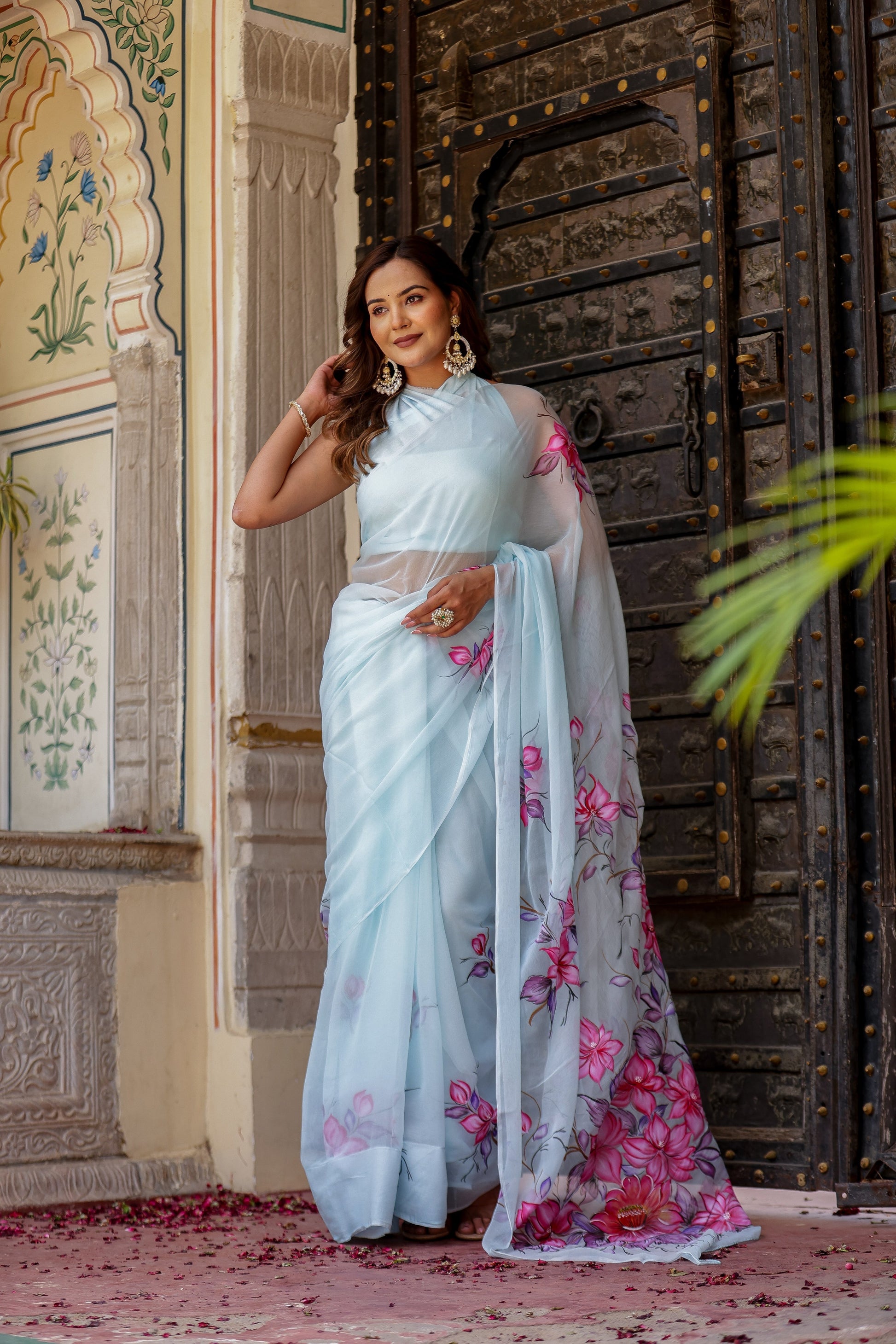 Elegant Stylera handcrafted saree with floral print, featuring a light blue fabric and delicate floral designs