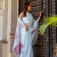 Elegant handcrafted saree with floral print in light blue, styled with a sheer dupatta for a traditional look