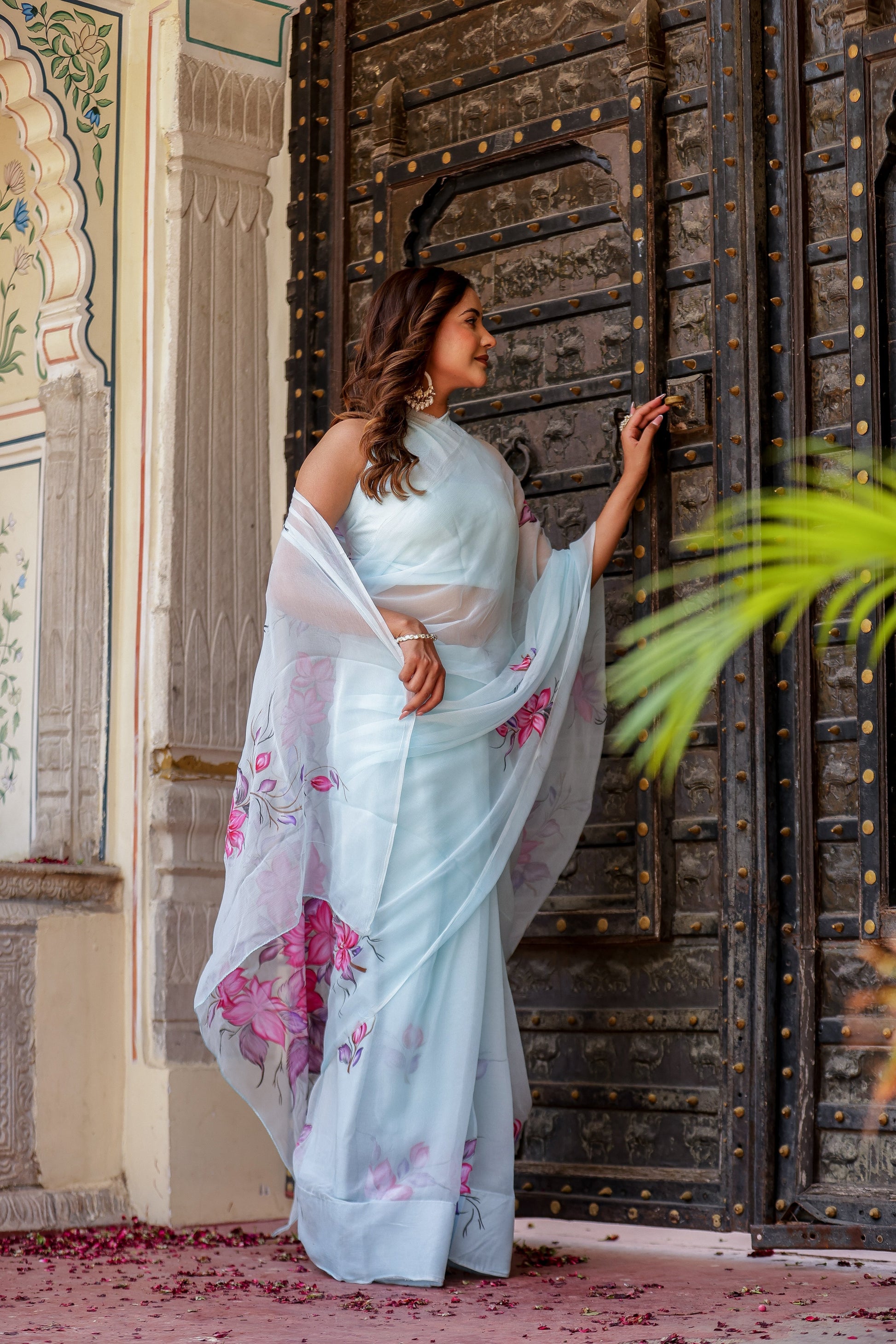 Elegant handcrafted saree with floral print in light blue, styled with a sheer dupatta for a traditional look