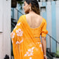 Elegant handpainted chiffon saree in vibrant orange with floral designs, styled for modern occasions