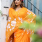 Vibrant handpainted chiffon saree in orange with floral designs, perfect for festive occasions