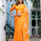 Elegant handpainted chiffon saree in vibrant orange with botanical designs, perfect for festive occasions