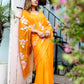 Stylera Handpainted chiffon saree in bright orange with floral patterns, elegantly draped on model