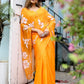 Stunning handpainted chiffon saree in vibrant orange with floral designs, perfect for festive occasions