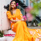 Elegant model wearing a vibrant handpainted chiffon saree in orange with floral designs, seated outdoors