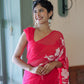 Elegant handpainted chiffon saree rani pink draped on a model, showcasing floral designs and a stylish look
