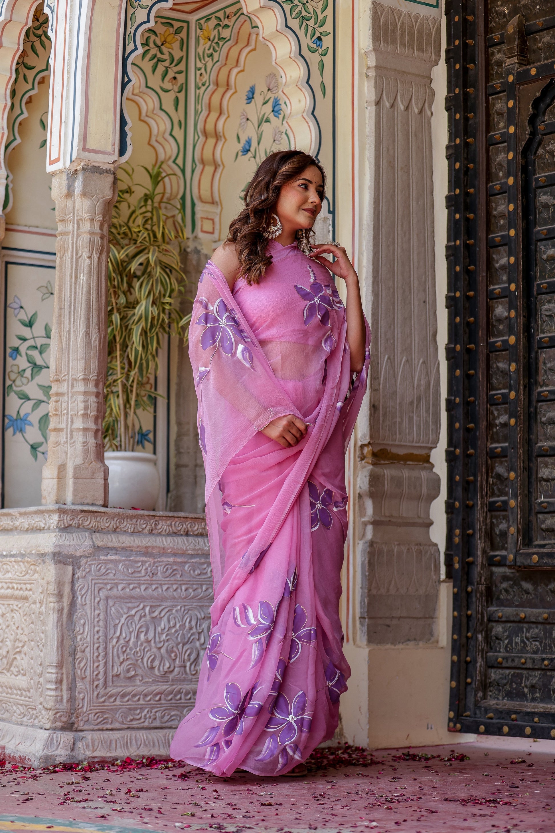 Elegant handpainted lavender chiffon saree adorned with intricate floral designs, perfect for festive occasions