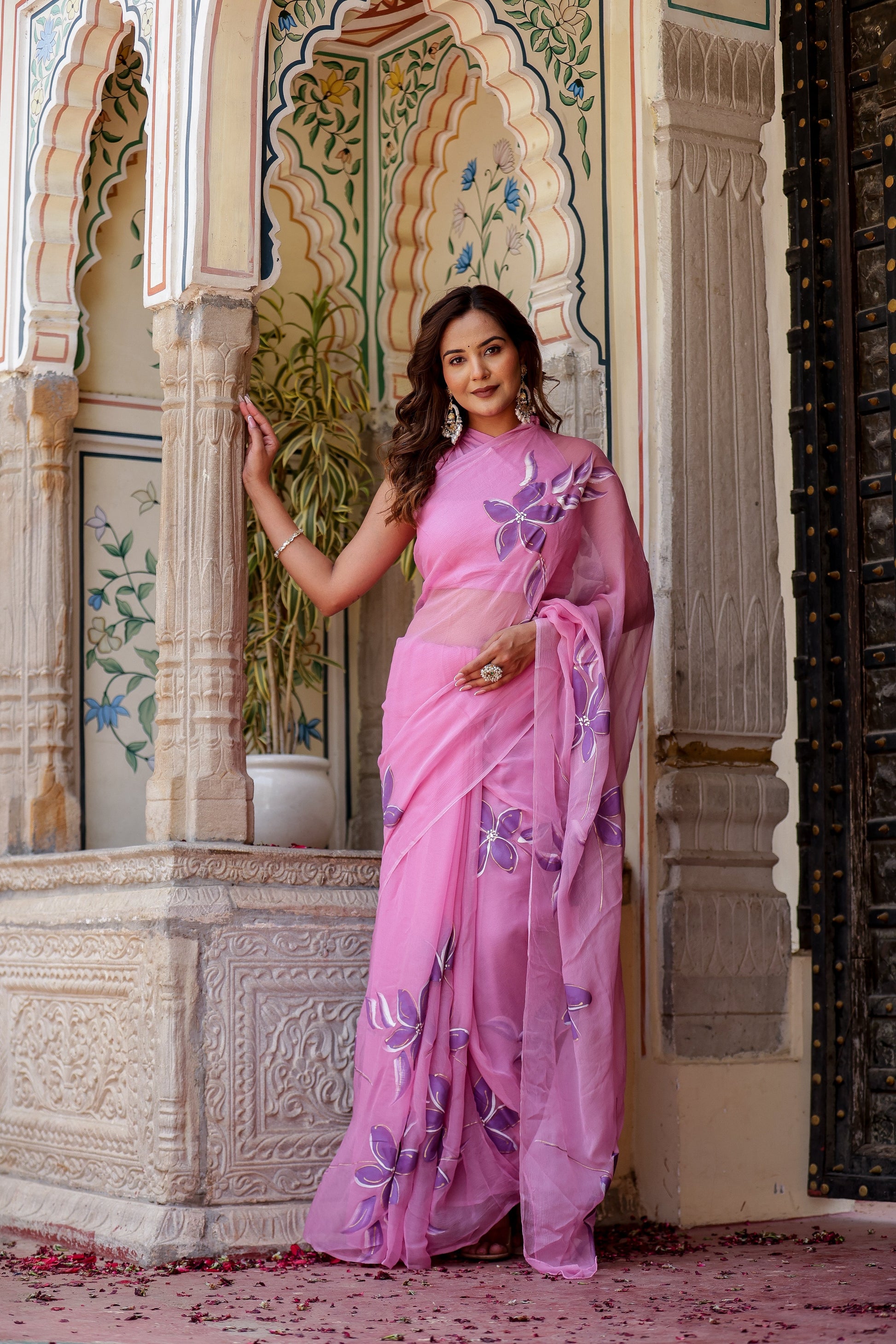 Elegant model showcasing a handpainted lavender chiffon saree with delicate floral designs