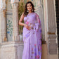 Elegant woman wearing a handpainted lavender chiffon saree with floral designs in a historic setting