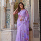 Elegant handpainted lavender chiffon saree adorned with floral designs, perfect for festive occasions