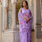 Elegant model wearing a handpainted lavender chiffon saree with floral designs, showcasing traditional style