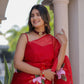 Model wearing a handpainted red organza saree with floral designs, perfect for festive occasions
