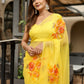 Elegant handpainted yellow chiffon saree adorned with floral designs, perfect for festive occasions
