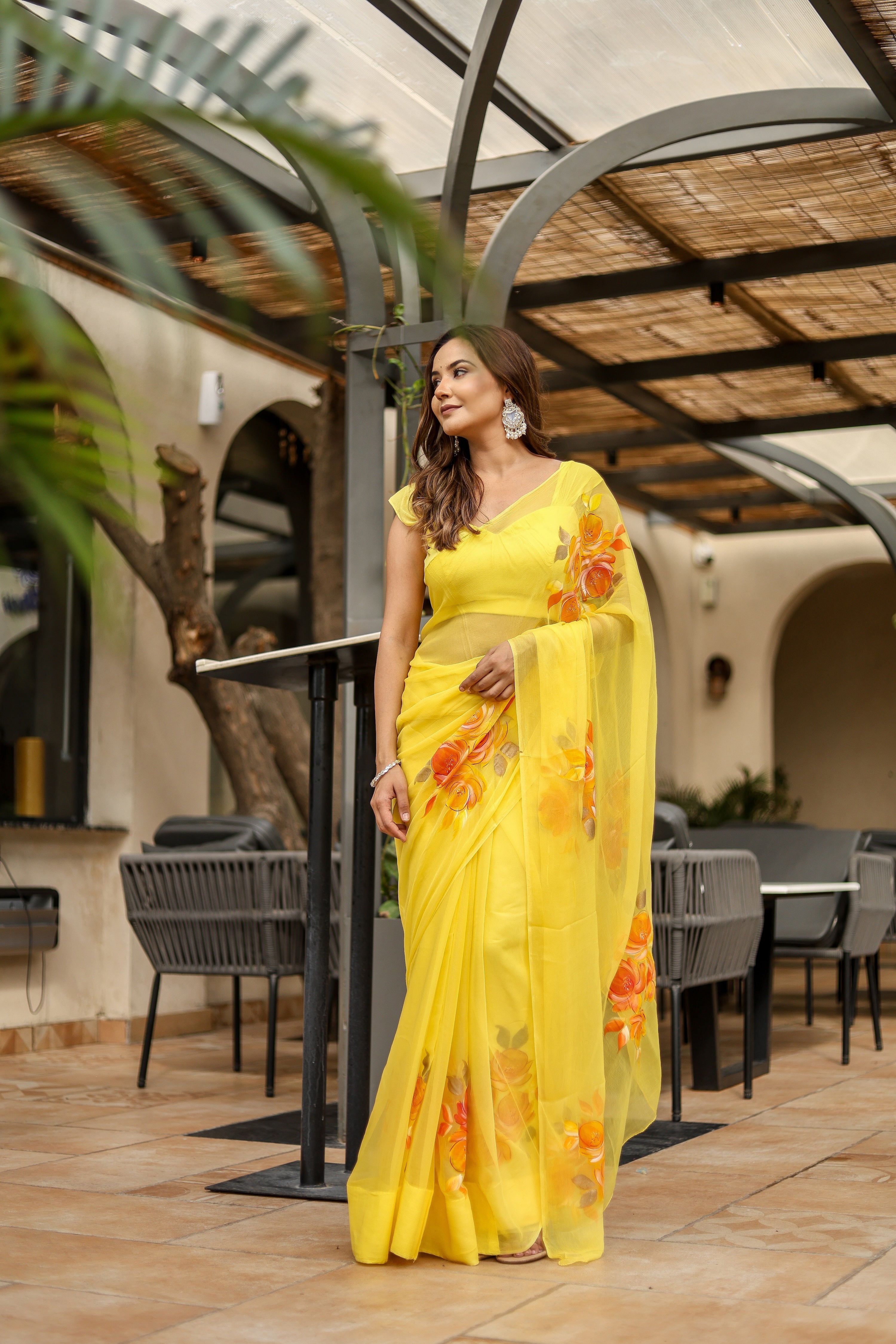Elegant handpainted yellow chiffon saree with floral design, perfect for festive occasions
