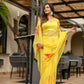 Elegant handpainted yellow chiffon saree with floral designs, perfect for festive occasions.