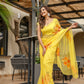 Elegant model wearing a handpainted yellow chiffon saree with floral designs, perfect for special occasions