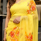 Handpainted yellow chiffon saree adorned with vibrant floral designs for elegant occasions