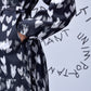 Close up of Stylera heart print black dress with waist tie long sleeve and pocket