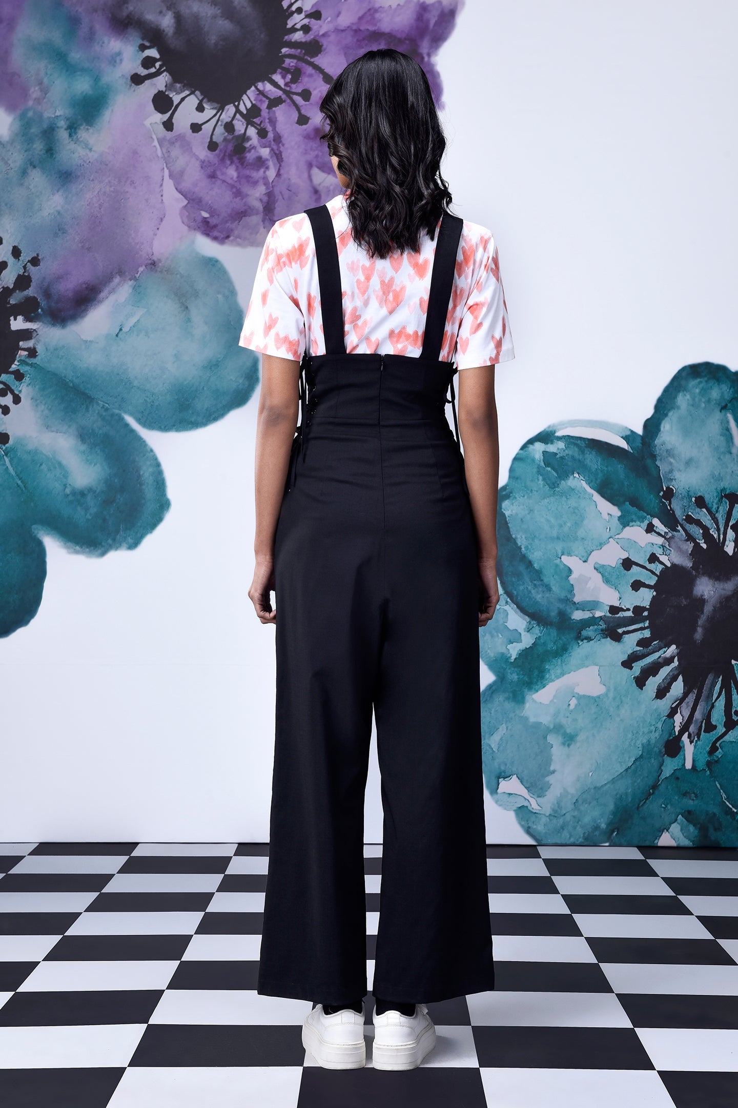 Back view of Stylera black dungaree with straps and wide legs high waist lace up overalls