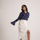Stylera ivory white draped skirt styled with navy blue blouse and white heels