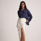Stylera ivory white draped skirt with a high slit worn with navy blouse and strappy heels