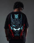 Person wearing a black t-shirt with a detailed graphic design on the back against a dark background