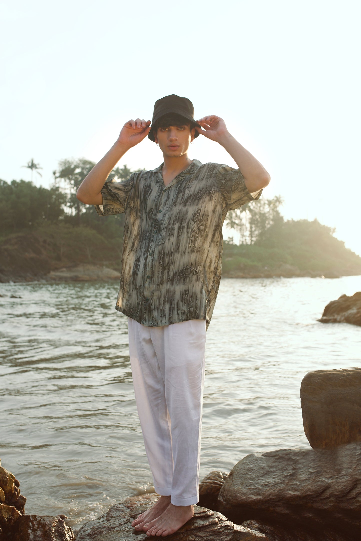 Khajuraho print men’s oversized shirt by Stylera worn by a model near the water