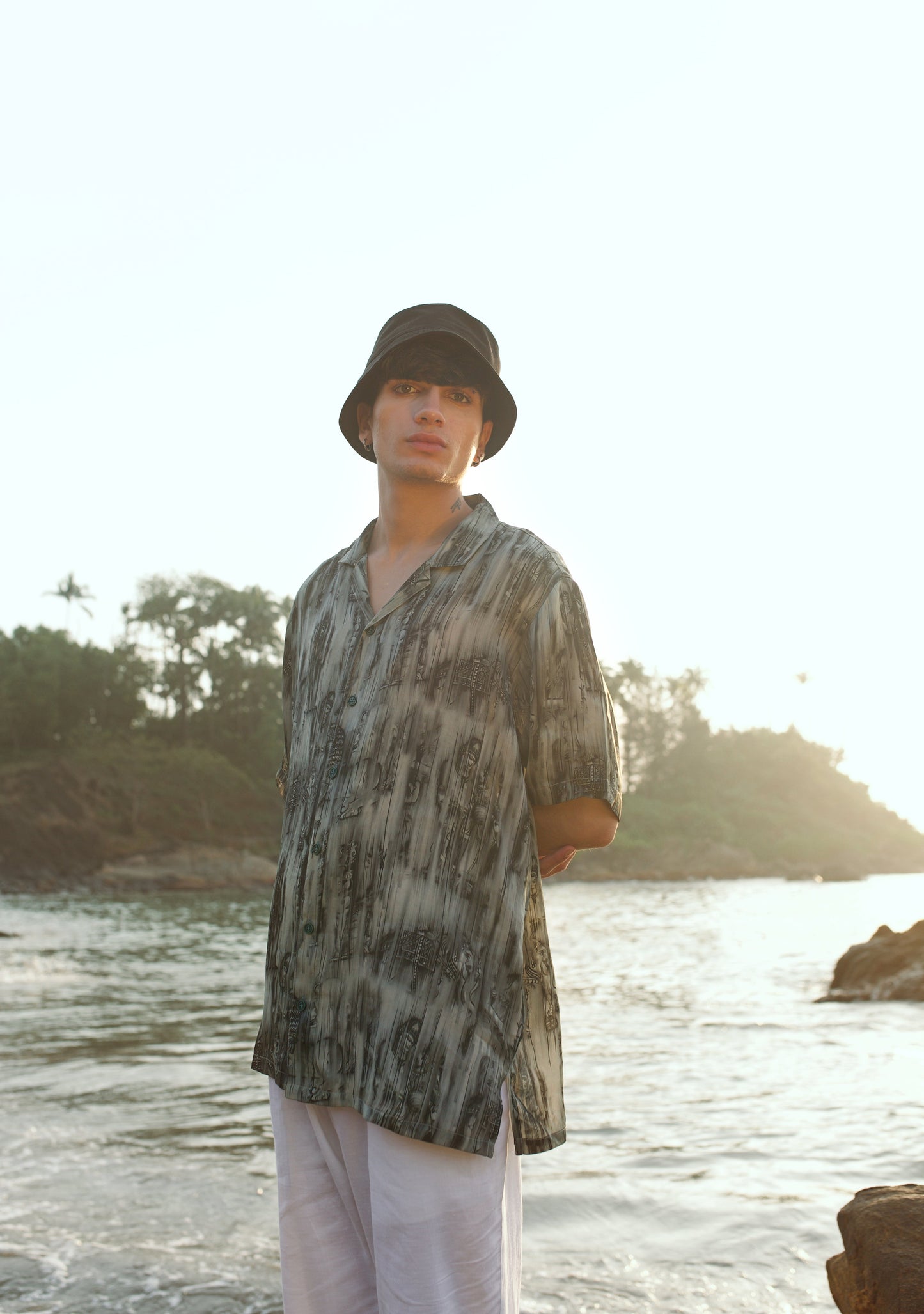 Khajuraho print men’s oversized shirt by Stylera in an outdoor beach setting