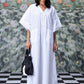 Stylera white cotton lace-up free size kaftan dress with V neck and front ties model holding black tote