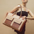 Stylish oversized tote bag in brown and beige, featuring a large tote purse with laptop compartment.