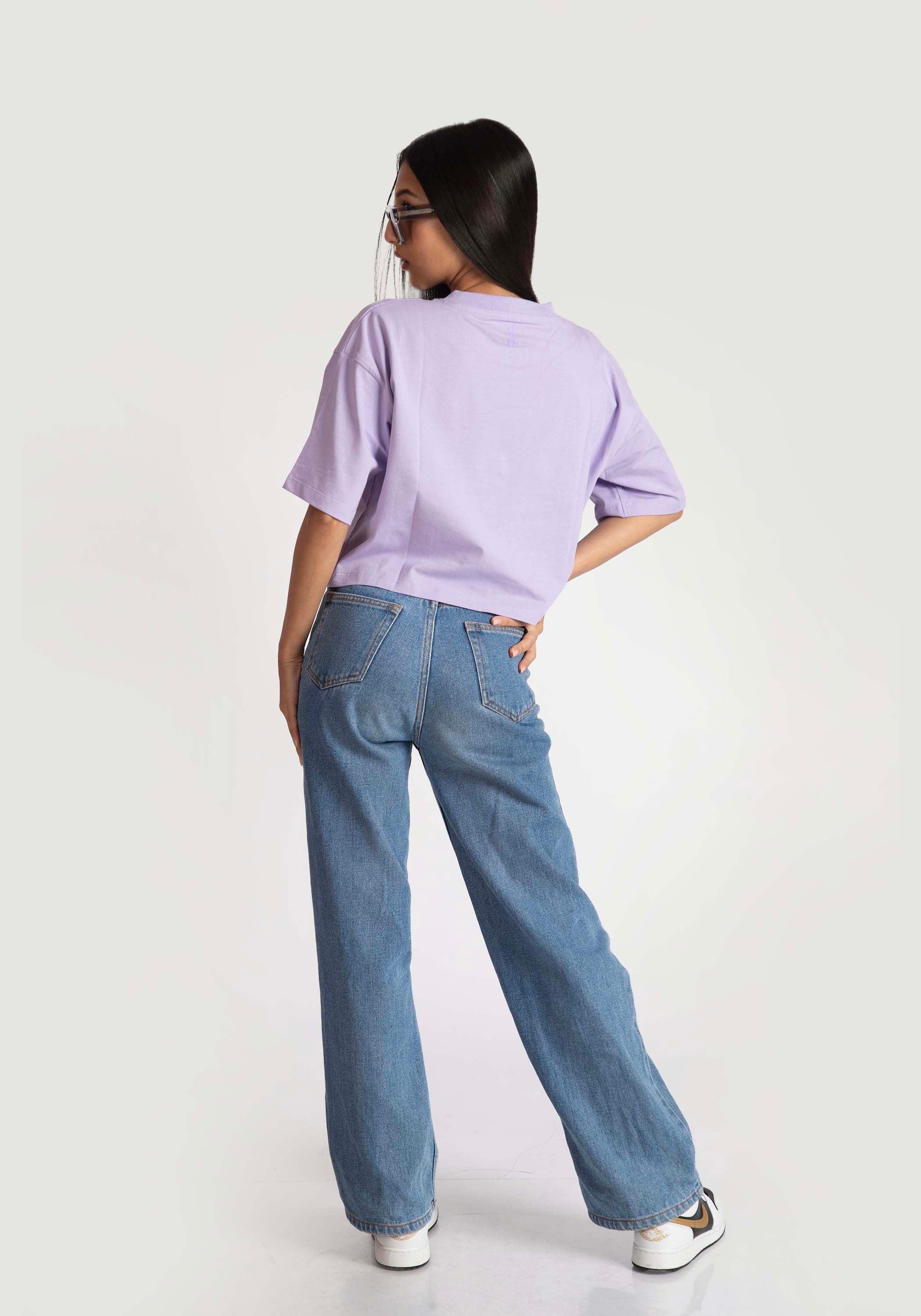 Stylera lavender oversized crop top worn by model paired with blue jeans and white sneakers