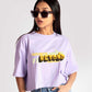 Stylera  lavender oversized crop top with graphic print worn by woman in sunglasses