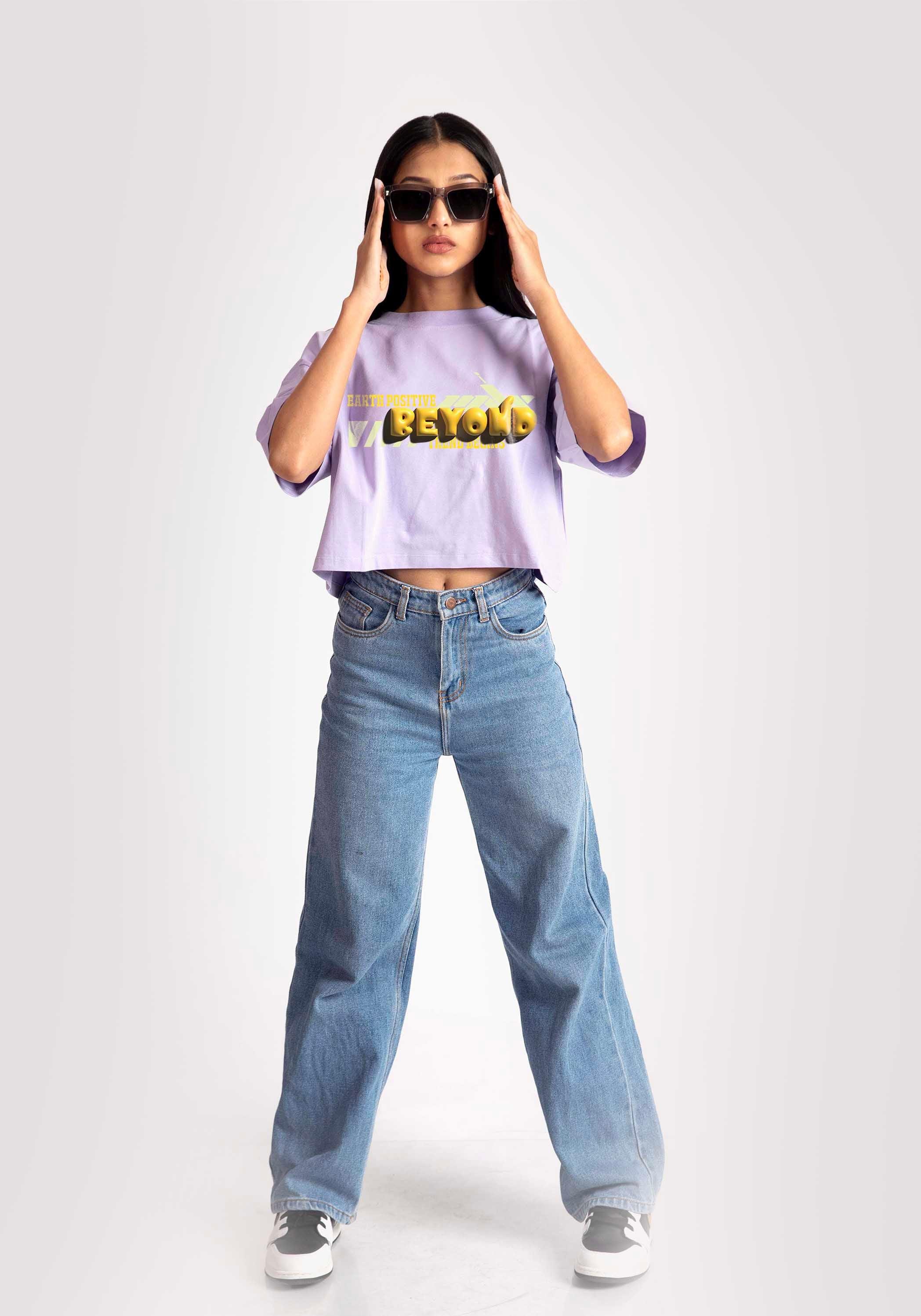 Stylera lavender oversized crop top worn by model with blue jeans and sunglasses